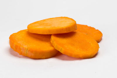 Close-up of orange slice against white background