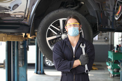 Portrait of mechanic wearing face mask working in garage