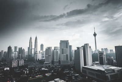 Skyscrapers against cloudy sky