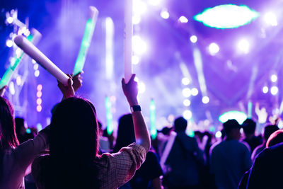 Rear view of people enjoying at music concert