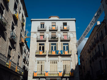 Low angle view of buildings against blue sky