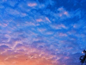 Low angle view of cloudy sky at sunset