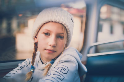 Portrait of girl sitting in bus