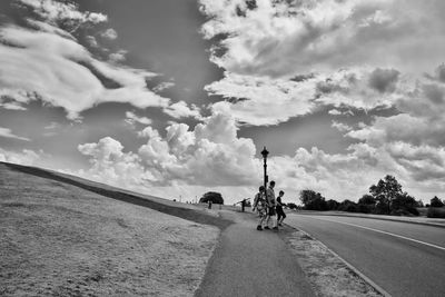 Bicycle on road against sky
