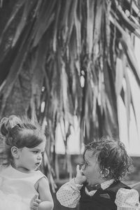 Cute boy and girl against trees