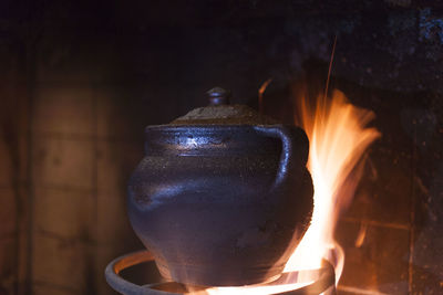 Close-up of burning candles on wood