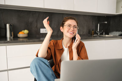 Young woman using laptop at home