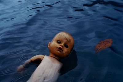 High angle view of abandoned doll in lake