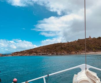 Boat sailing in sea against sky