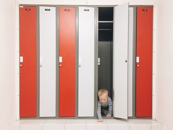 Playful boy hiding in locker