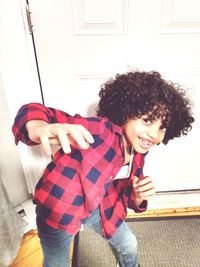 Portrait of smiling girl standing at home