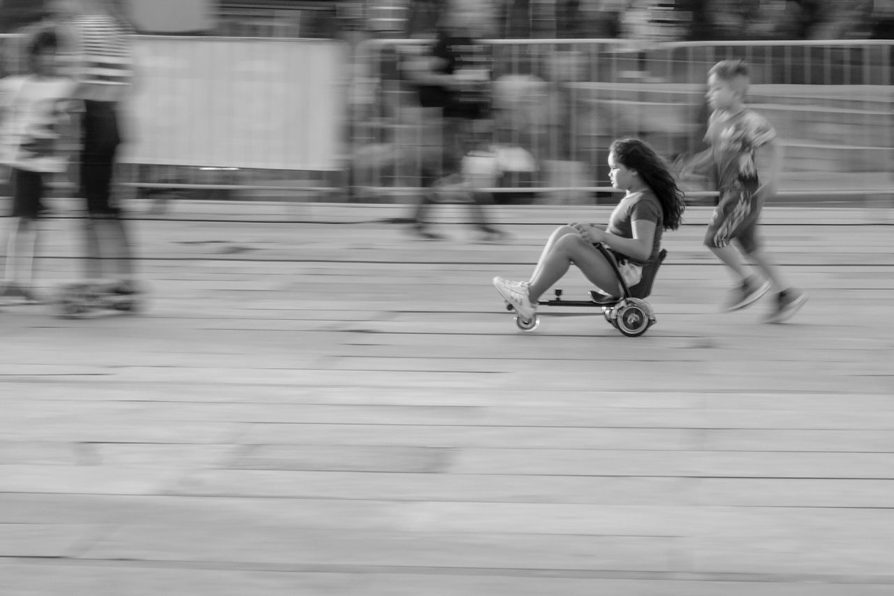 BLURRED MOTION OF WOMAN RIDING MOTORCYCLE