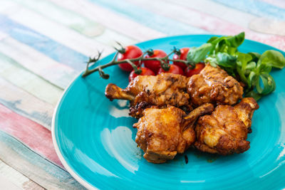 High angle view of fried meat in plate on table