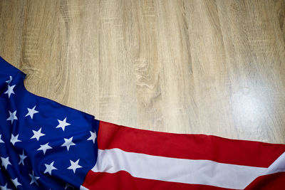 Close-up of american flag on wooden floor