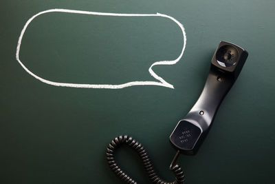 High angle view of telephone receiver on table