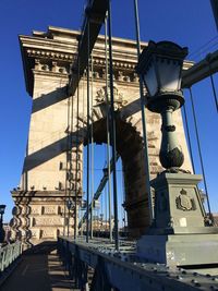 Low angle view of bridge against clear blue sky