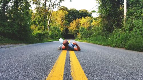 Man lying down on road