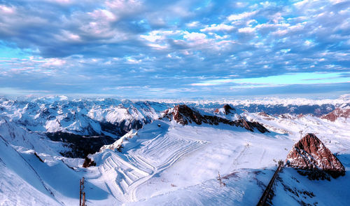 Wide angle aerial panorama of sunny austria alps under dramatic clouds