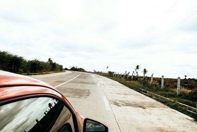 Road against sky seen through car windshield