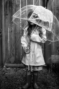 Full length of a girl standing on wet rainy day