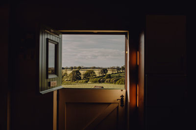 Buildings seen through window of house