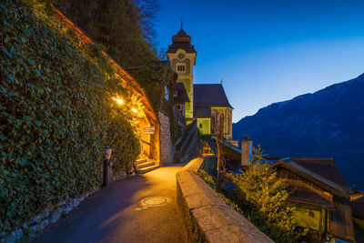 Illuminated amidst buildings against sky at night