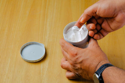 Cropped hand of person washing hands on table
