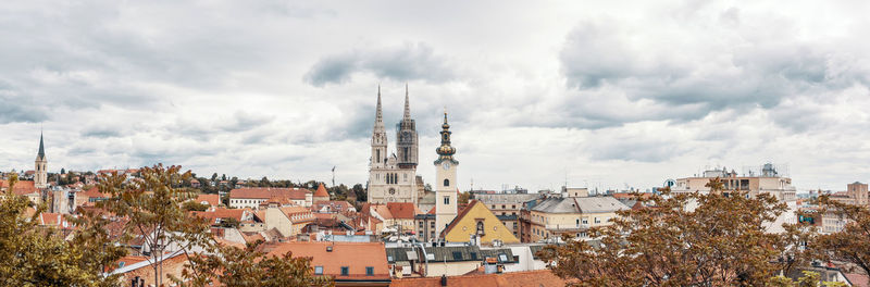 High angle view of buildings against cloudy sky