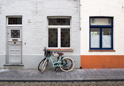 Bicycle on street against building