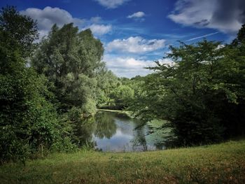 Scenic view of lake against cloudy sky