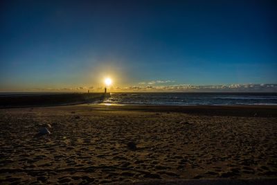 Scenic view of beach at sunset