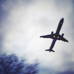 Low angle view of airplane flying in sky