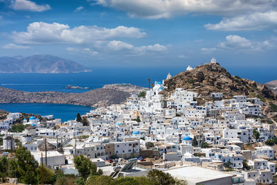 High angle view of townscape by sea against sky