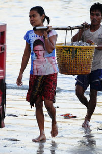 Full length of friends on beach