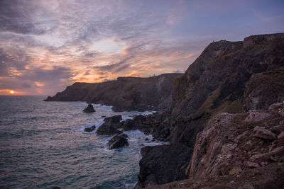 Scenic view of sea against sky during sunset at kynance cove