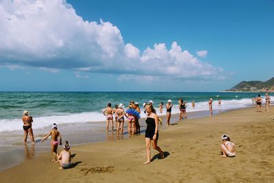 People on beach against sky