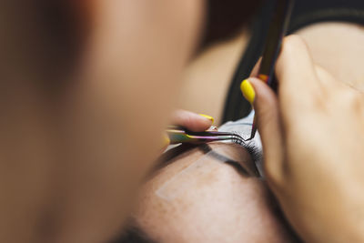 Close-up of hand holding book
