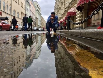 Reflection of buildings in puddle
