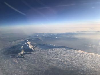 Aerial view of snowcapped mountains against sky