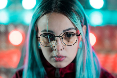 Close-up portrait of young woman wearing eyeglasses