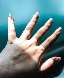Close-up of human hand by car window