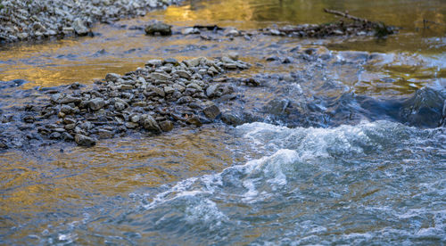 Stream flowing through rocks in sea