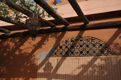 Low angle view of metallic structure against trees