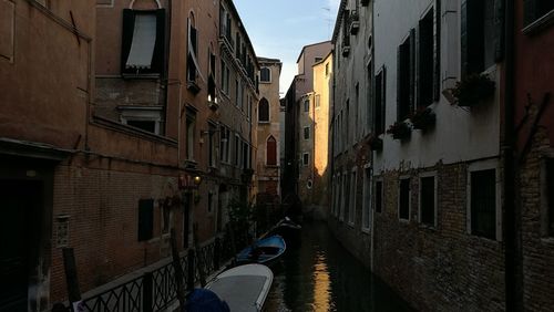 Alley amidst buildings in city against sky