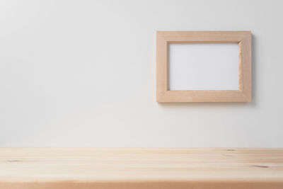 Empty chair on hardwood floor against wall at home