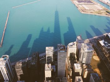 Shadow of city skyline on sea