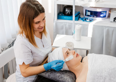 Side view of young woman working in clinic