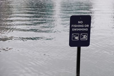 No fishing or swimming sign at edge of water