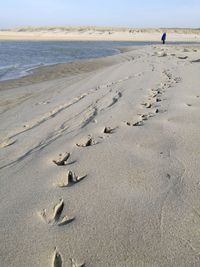 Footprints on sand at beach