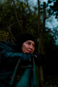 Portrait of woman looking away in forest